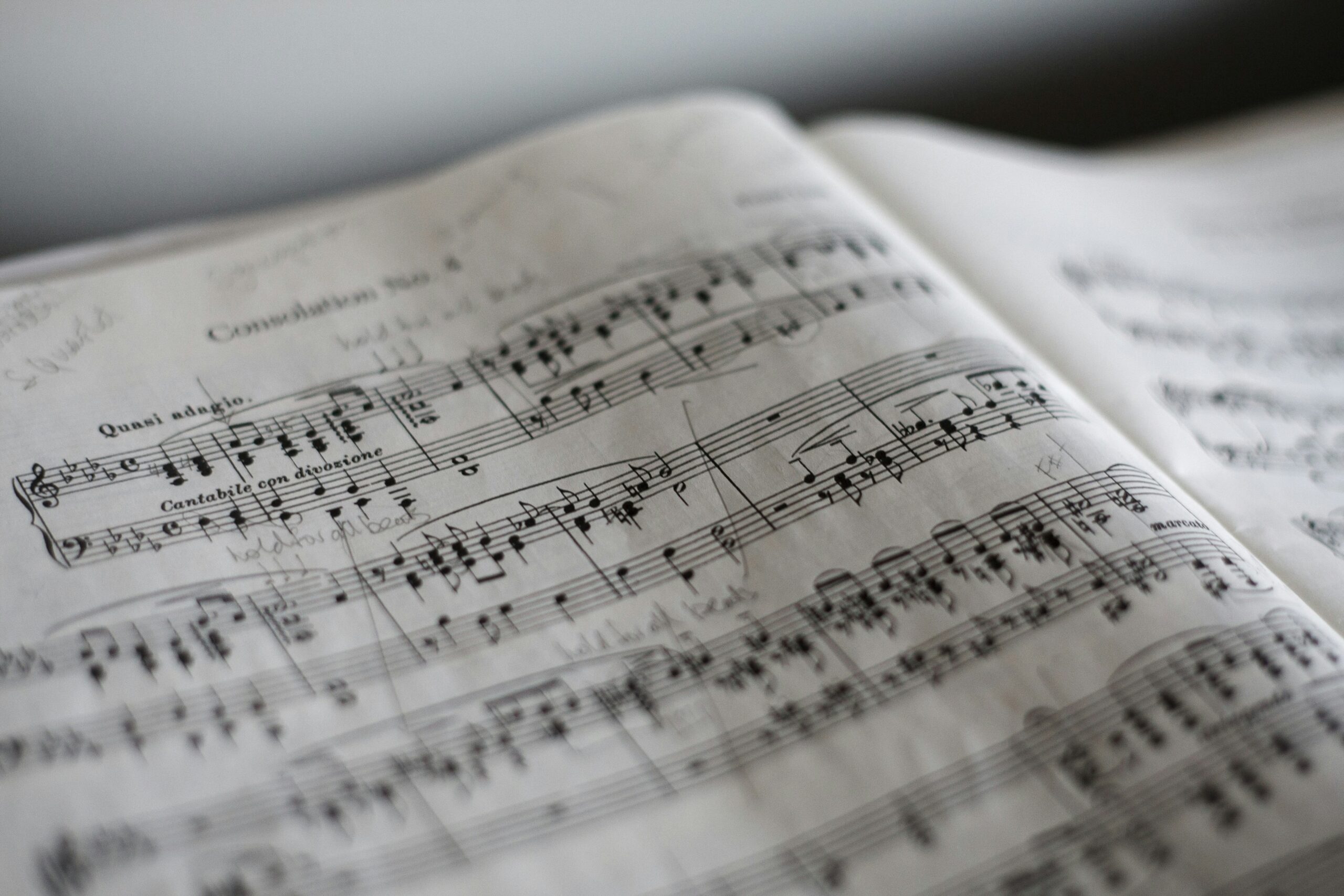 Close-up of a printed musical score with notes on staff lines, edges slightly blurred